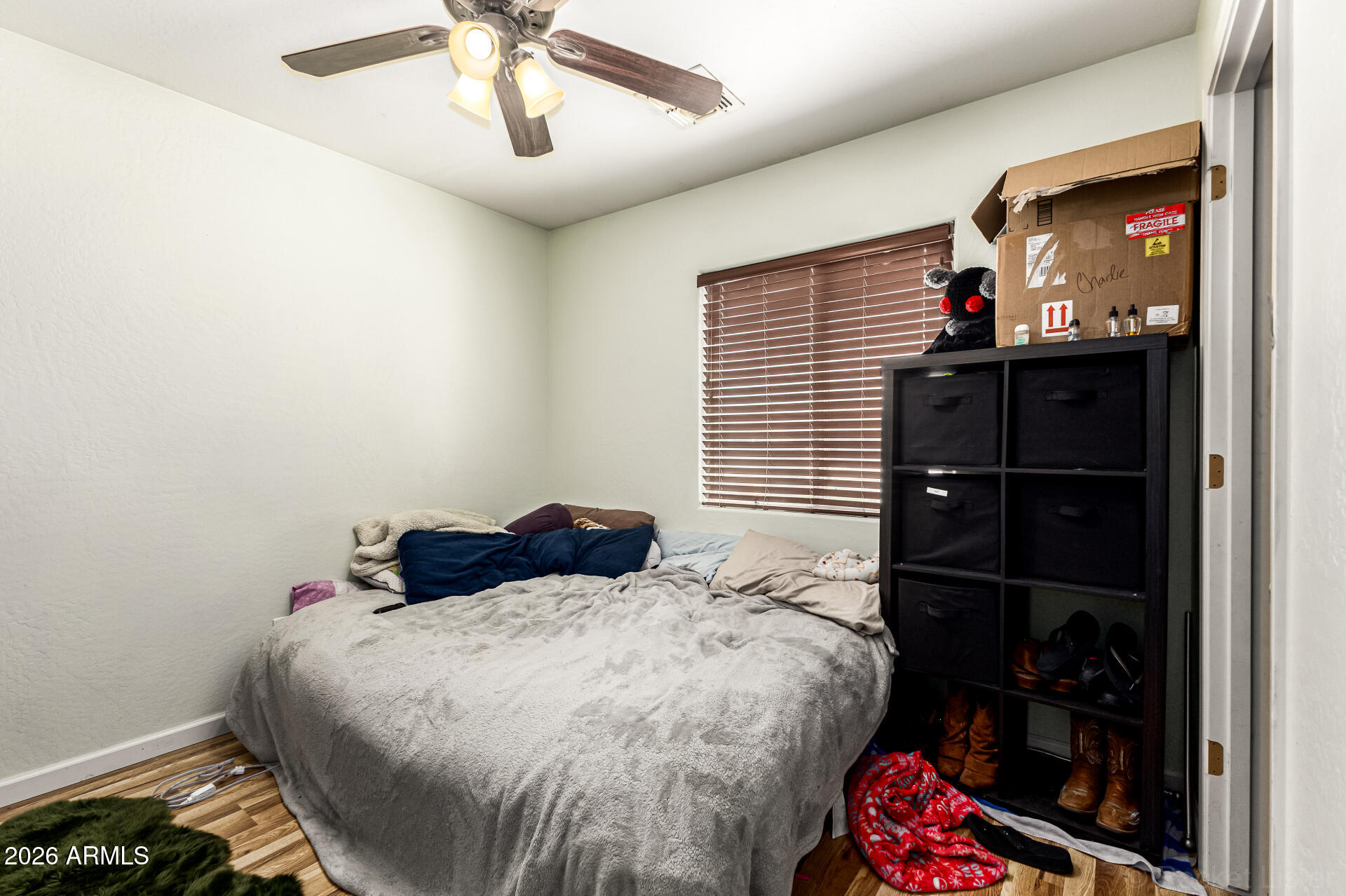 40264 West Lococo Street Maricopa, AZ 85138 - Photo 17 of 29 a bedroom with a bed and a window