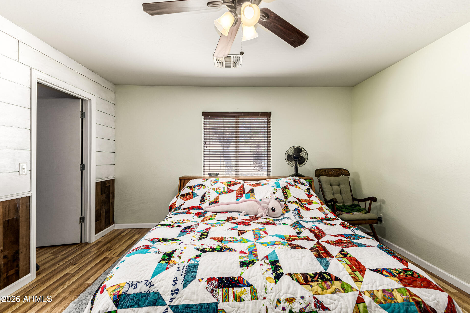 40264 West Lococo Street Maricopa, AZ 85138 - Photo 20 of 29 a bedroom with bed and wooden floor