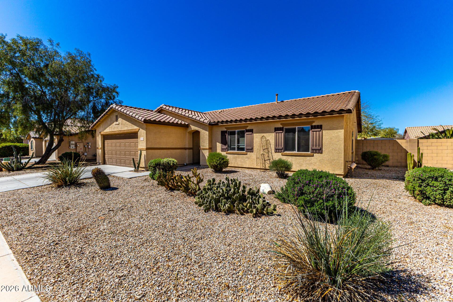 40264 West Lococo Street Maricopa, AZ 85138 - Photo 2 of 29 a front view of a house with a yard