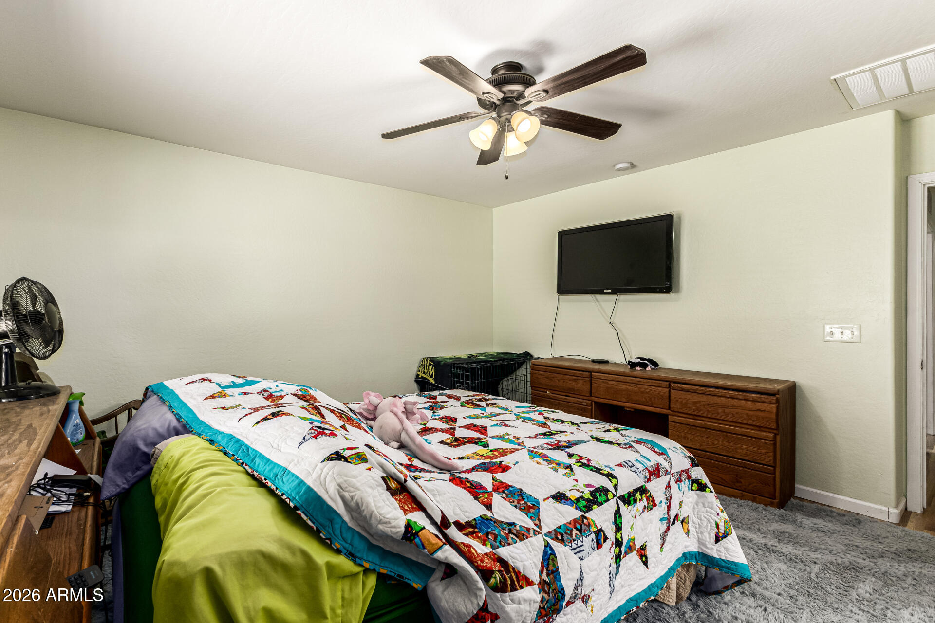 40264 West Lococo Street Maricopa, AZ 85138 - Photo 21 of 29 a bedroom with a bed a flat tv screen and a walk in closet