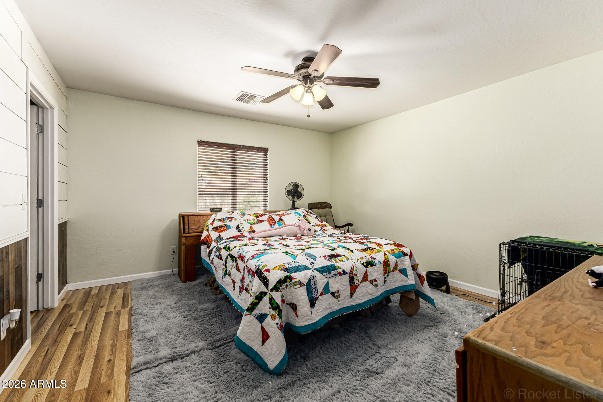 40264 West Lococo Street Maricopa, AZ 85138 - Photo 22 of 29 a bedroom with a bed and a chandelier