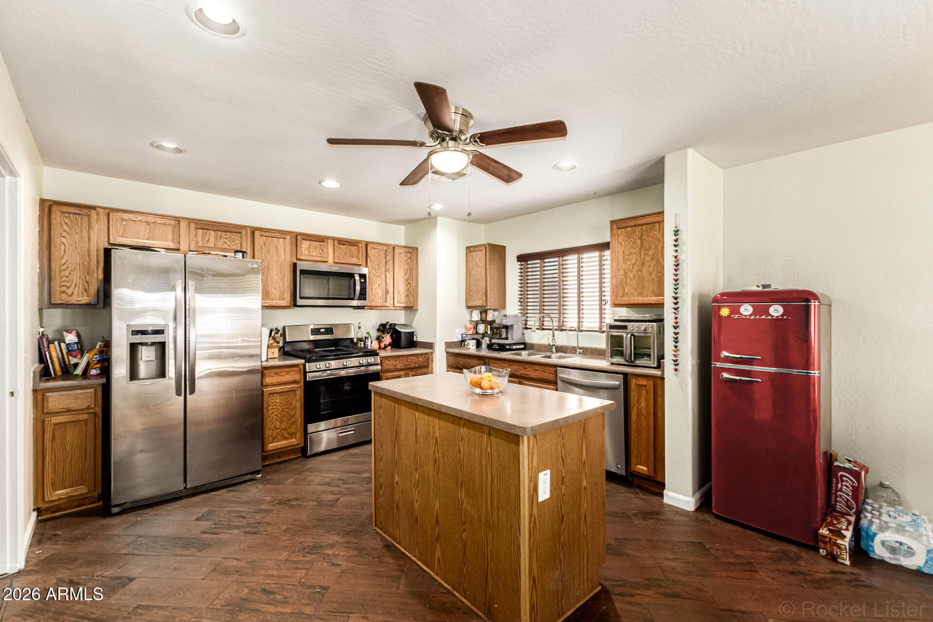 40264 West Lococo Street Maricopa, AZ 85138 - Photo 25 of 29 a kitchen with stainless steel appliances granite countertop a refrigerator a sink a stove and a refrigerator