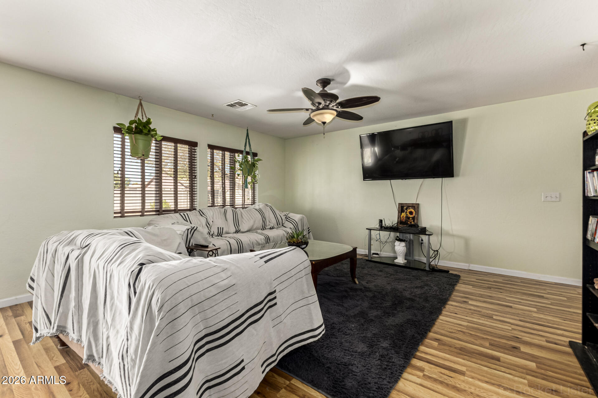 40264 West Lococo Street Maricopa, AZ 85138 - Photo 28 of 29 a bedroom with a bed a flat screen tv and a rug