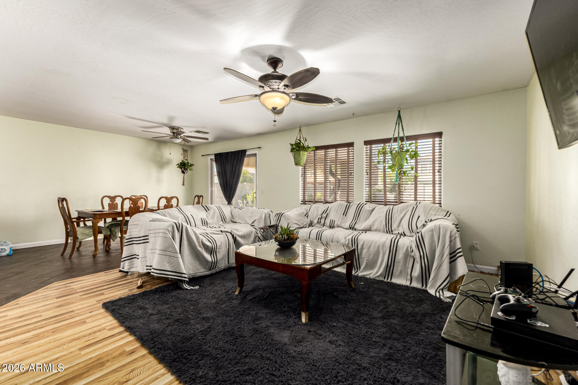40264 West Lococo Street Maricopa, AZ 85138 - Photo 29 of 29 a living room with furniture a chandelier and a rug