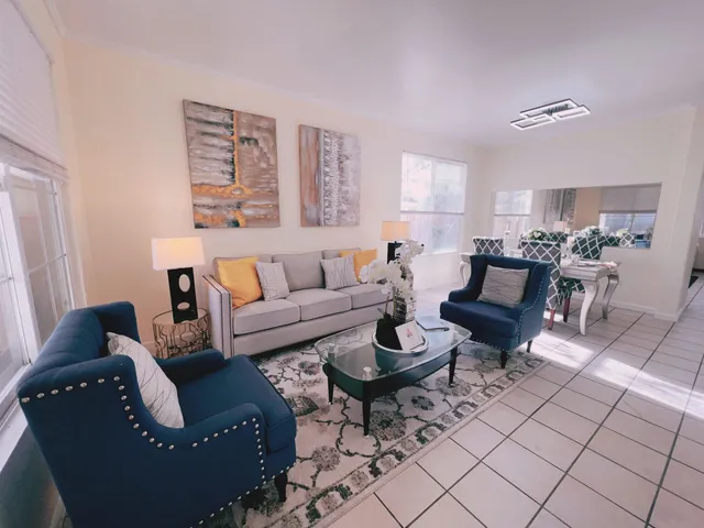 a living room with furniture rug and window