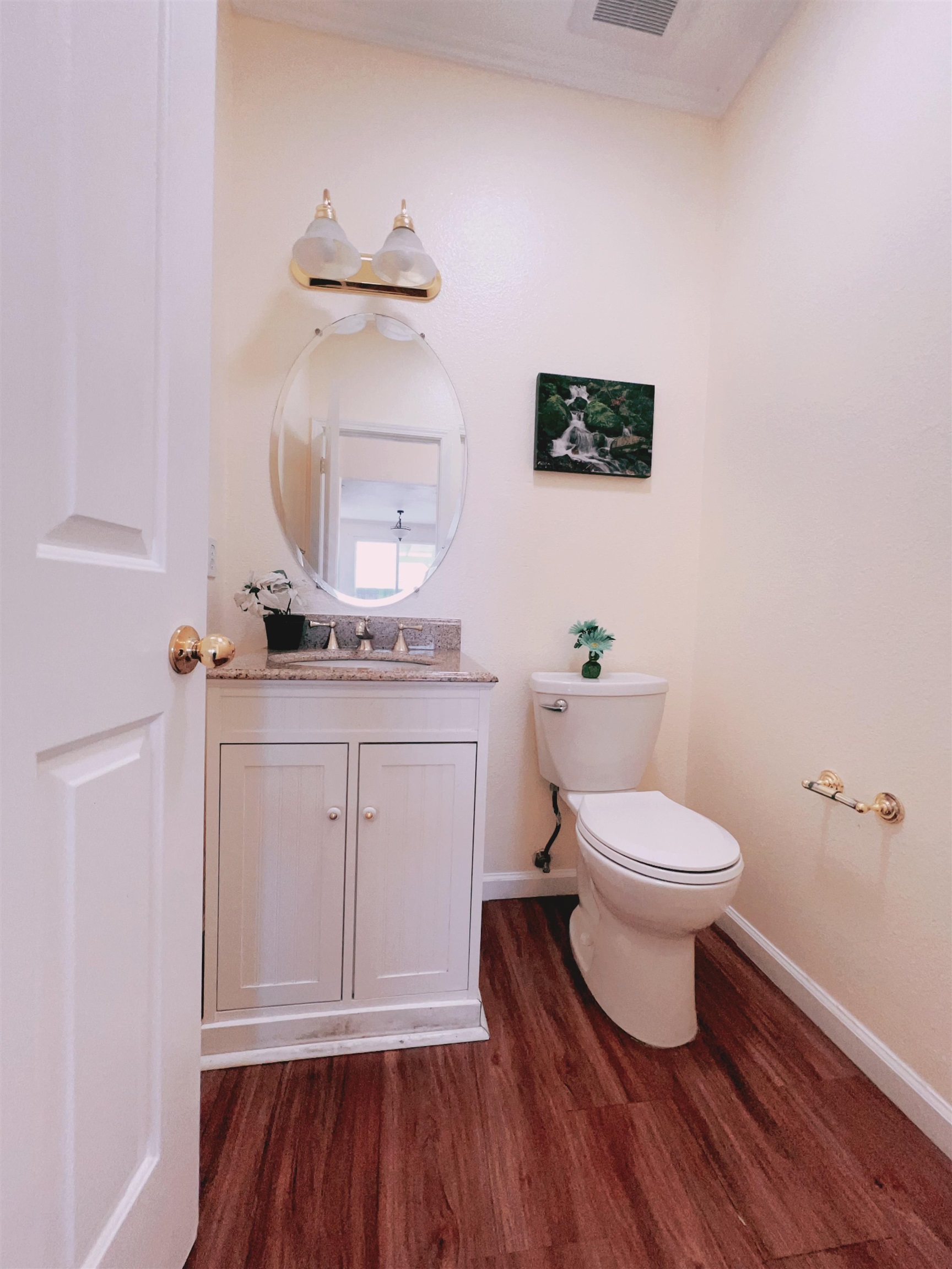 19 Quartz Court Pittsburg, CA 94565 - Photo 14 of 27 a bathroom with a toilet a sink and wooden floor