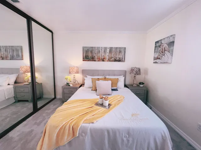 a bedroom with a large bed and a chandelier