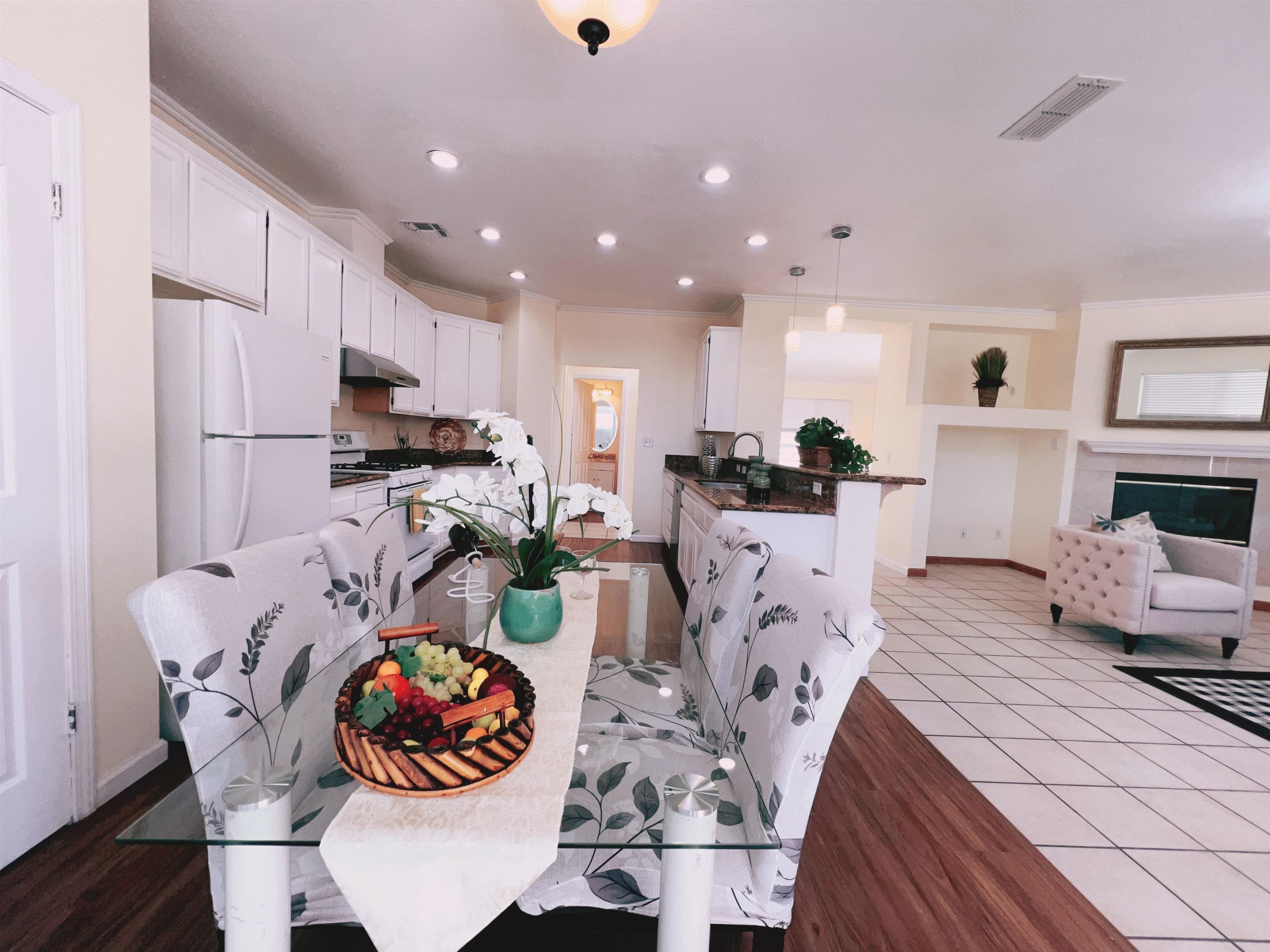 19 Quartz Court Pittsburg, CA 94565 - Photo 5 of 27 a kitchen with stainless steel appliances kitchen island granite countertop a sink chairs and a refrigerator