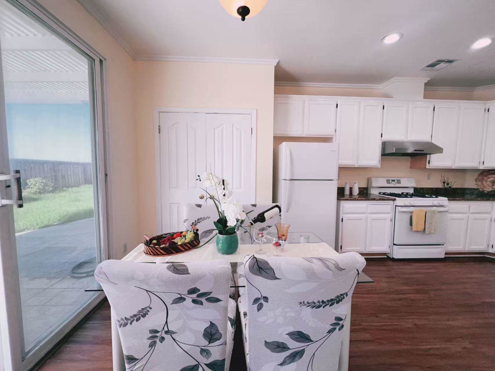 19 Quartz Court Pittsburg, CA 94565 - Photo 7 of 27 a kitchen with stainless steel appliances granite countertop a stove a refrigerator a sink a dining table and chairs