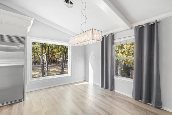 a kitchen with stainless steel appliances kitchen island granite countertop a stove a sink and a refrigerator