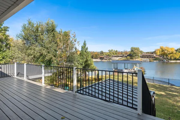 a view of balcony with wooden floor and fence