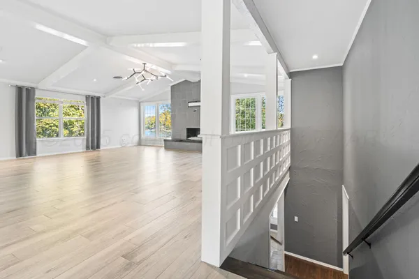 a living room with a fireplace and a floor to ceiling window