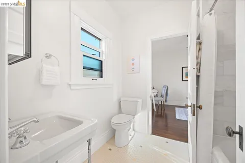 a bedroom with bed and a painting on the wall