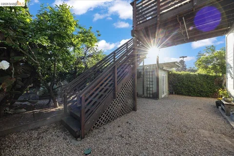 a view of balcony with wooden floor and trees