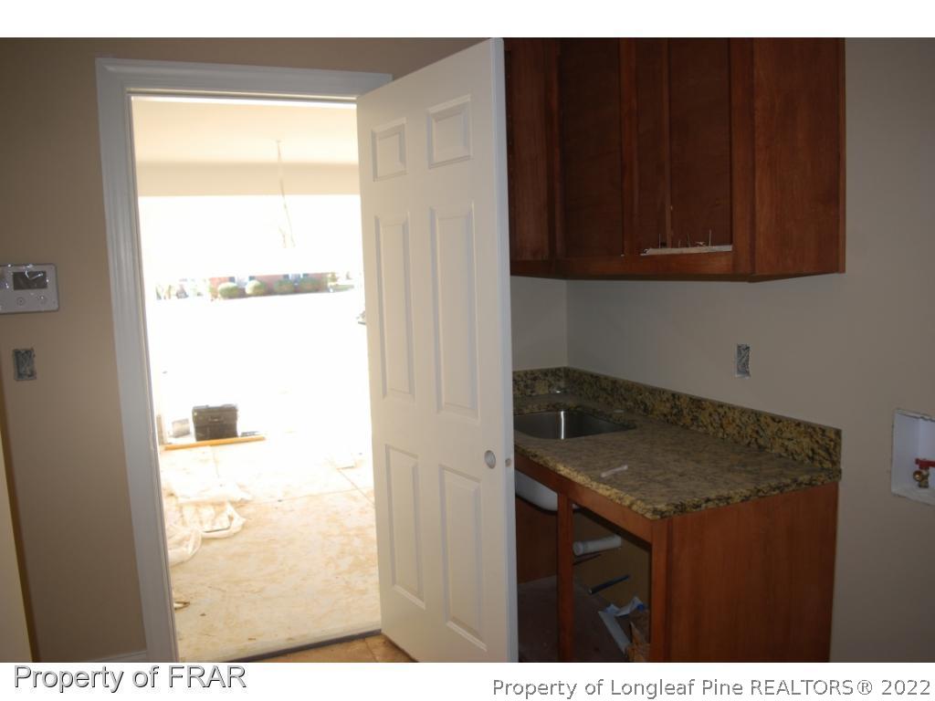 270 Falling Water Road Spring Lake, NC 28390 - Photo 3 of 34 a kitchen with a sink and cabinets