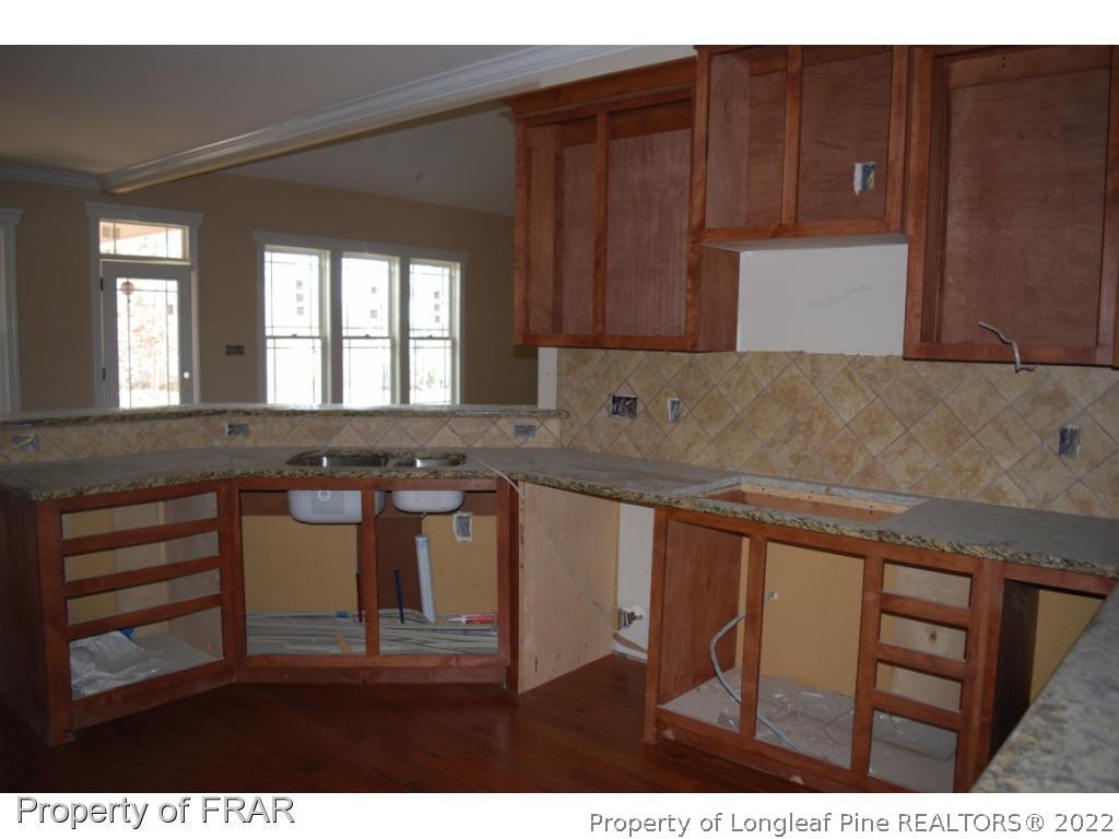 270 Falling Water Road Spring Lake, NC 28390 - Photo 5 of 34 a kitchen with granite countertop a sink cabinets and wooden floor