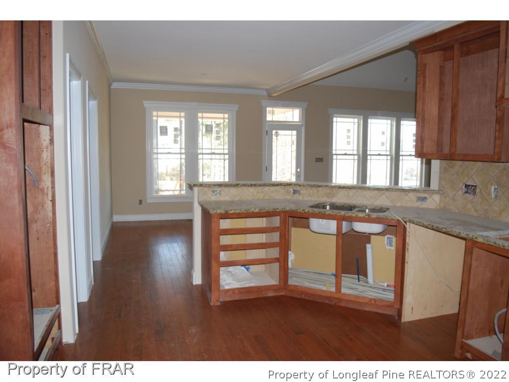 270 Falling Water Road Spring Lake, NC 28390 - Photo 6 of 34 a kitchen with granite countertop a stove a sink and a microwave