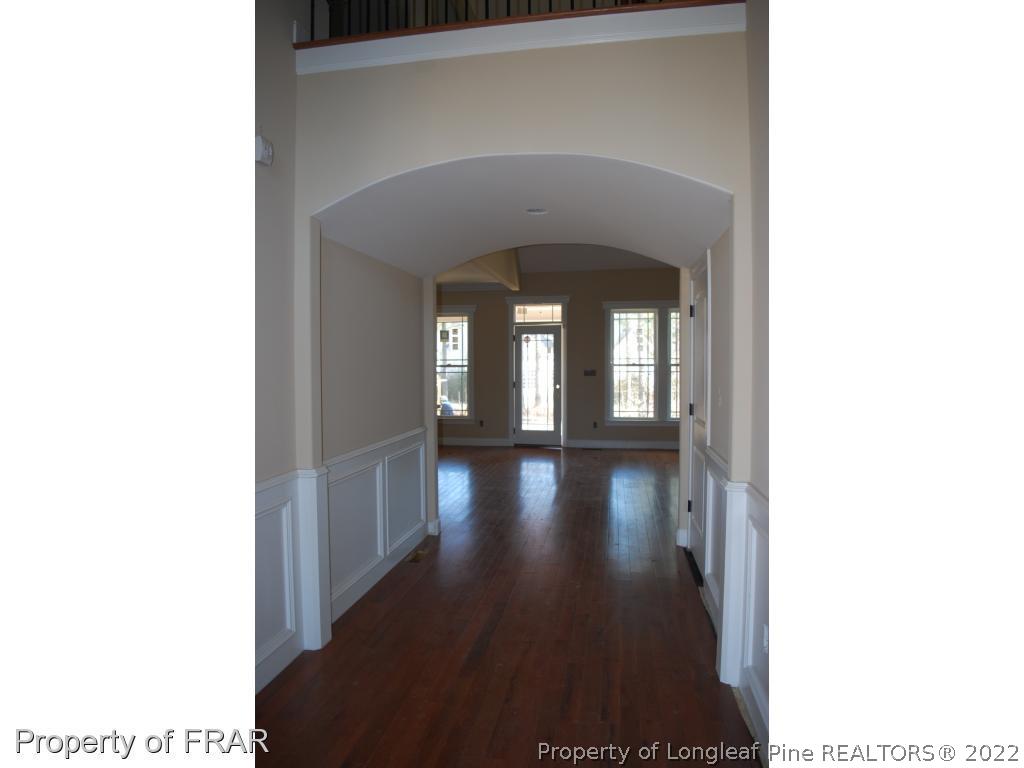 270 Falling Water Road Spring Lake, NC 28390 - Photo 8 of 34 a view of a hallway with wooden floor and a living room