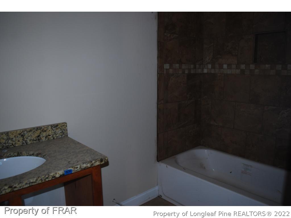 270 Falling Water Road Spring Lake, NC 28390 - Photo 10 of 34 a bathroom with a granite countertop sink