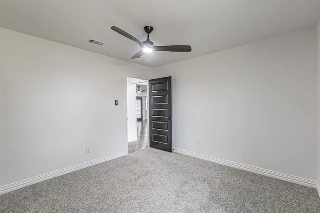 a spacious bathroom with a double vanity sink toilet and a mirror