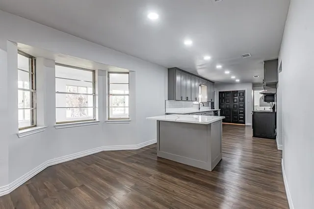 a kitchen with stainless steel appliances granite countertop a refrigerator sink and cabinets
