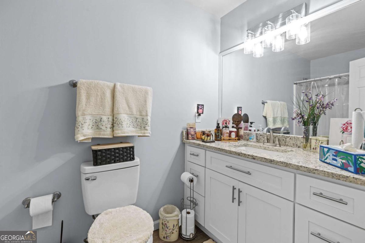 6324 Amberly Road Rex, GA 30273 - Photo 15 of 22 a bathroom with a toilet a sink and mirror