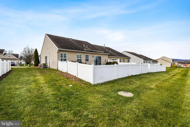 a view of a house with a yard and sitting area