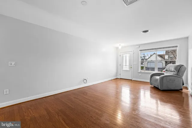 a view of an empty room and wooden floor