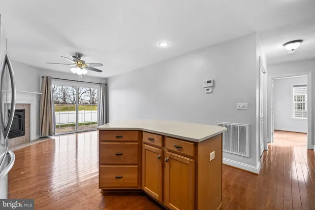 a view of a hallway with wooden floor and a window
