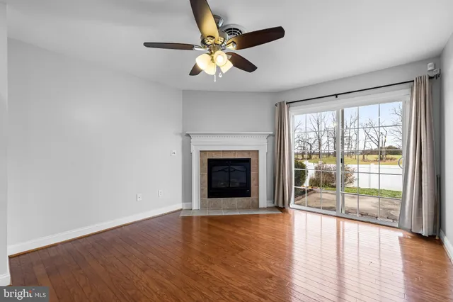 wooden floor fireplace and natural light in room