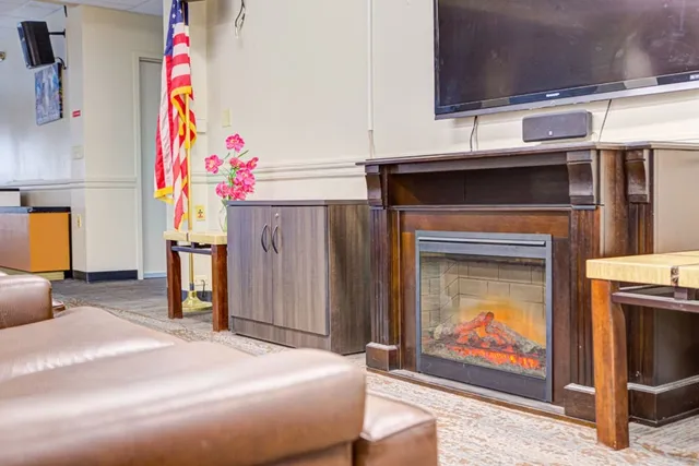 a bedroom with a bed and a fireplace