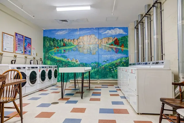 a view of a patio with a table and chairs