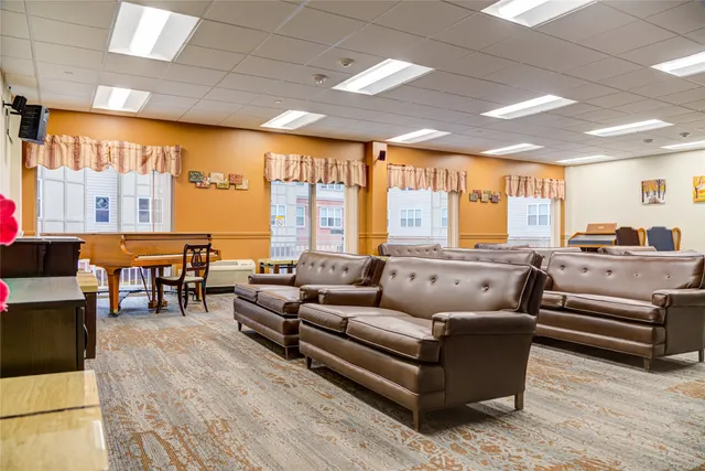 a living room with furniture and large windows