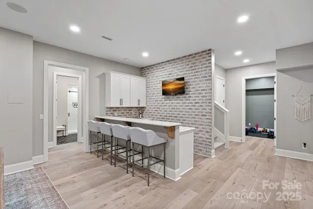 a living room with fireplace furniture and a chandelier