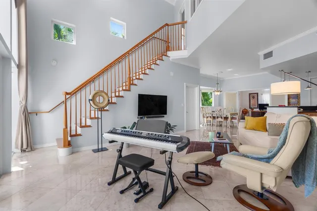 a living room with furniture and a baby crib