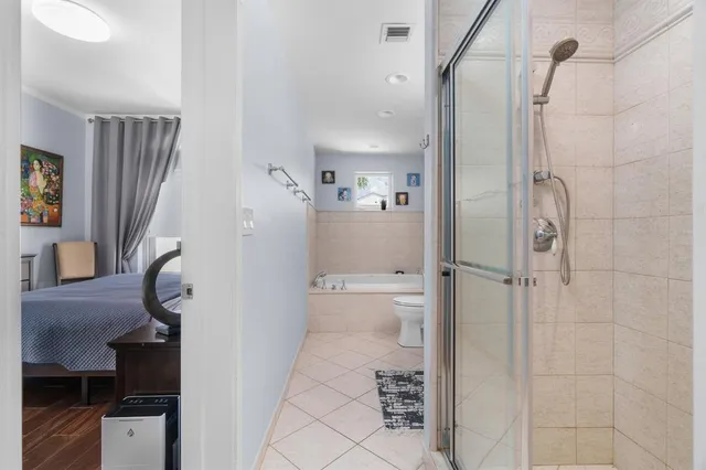 a bathroom with a toilet a shower and a sink