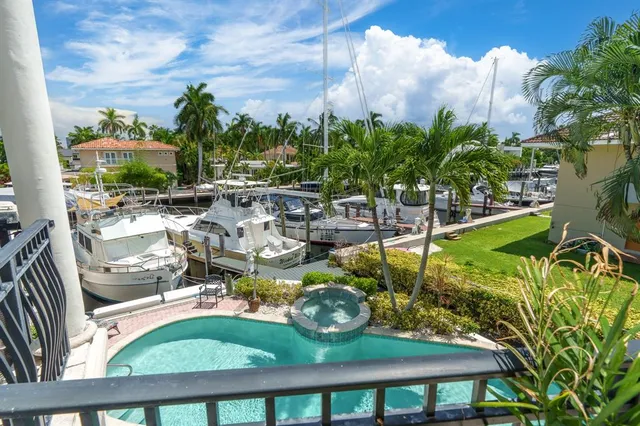 a kitchen with stainless steel appliances kitchen island granite countertop a table chairs and a refrigerator