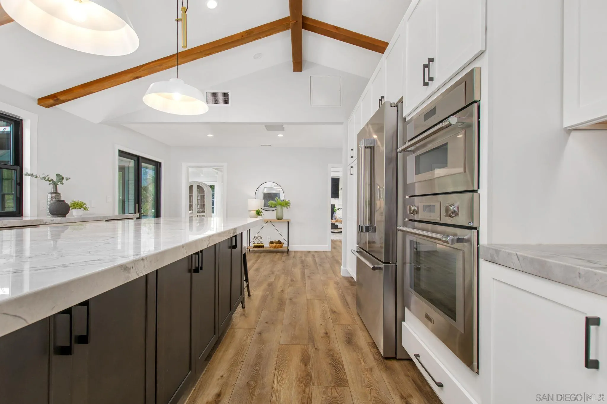 2335 Ivy Road Oceanside, CA 92054 - Photo 18 of 53 a kitchen with stainless steel appliances granite countertop a refrigerator a stove and a sink with wooden floor