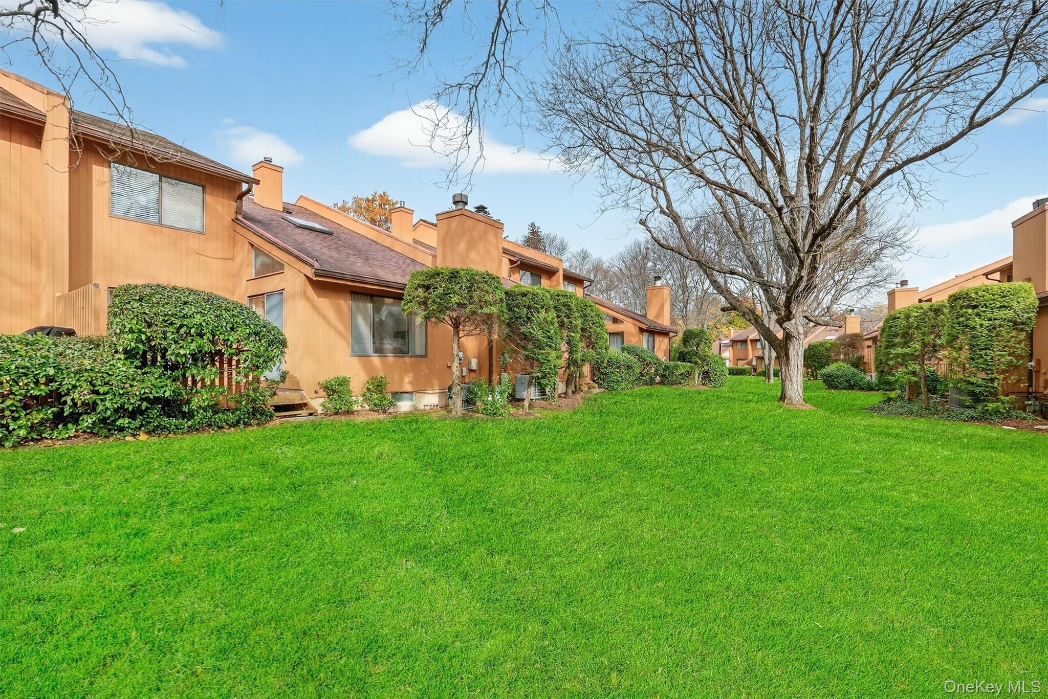 200 California Road, Unit 9 Mount Vernon, NY 10552 - Photo 41 of 50 a view of a house with a big yard and large tree