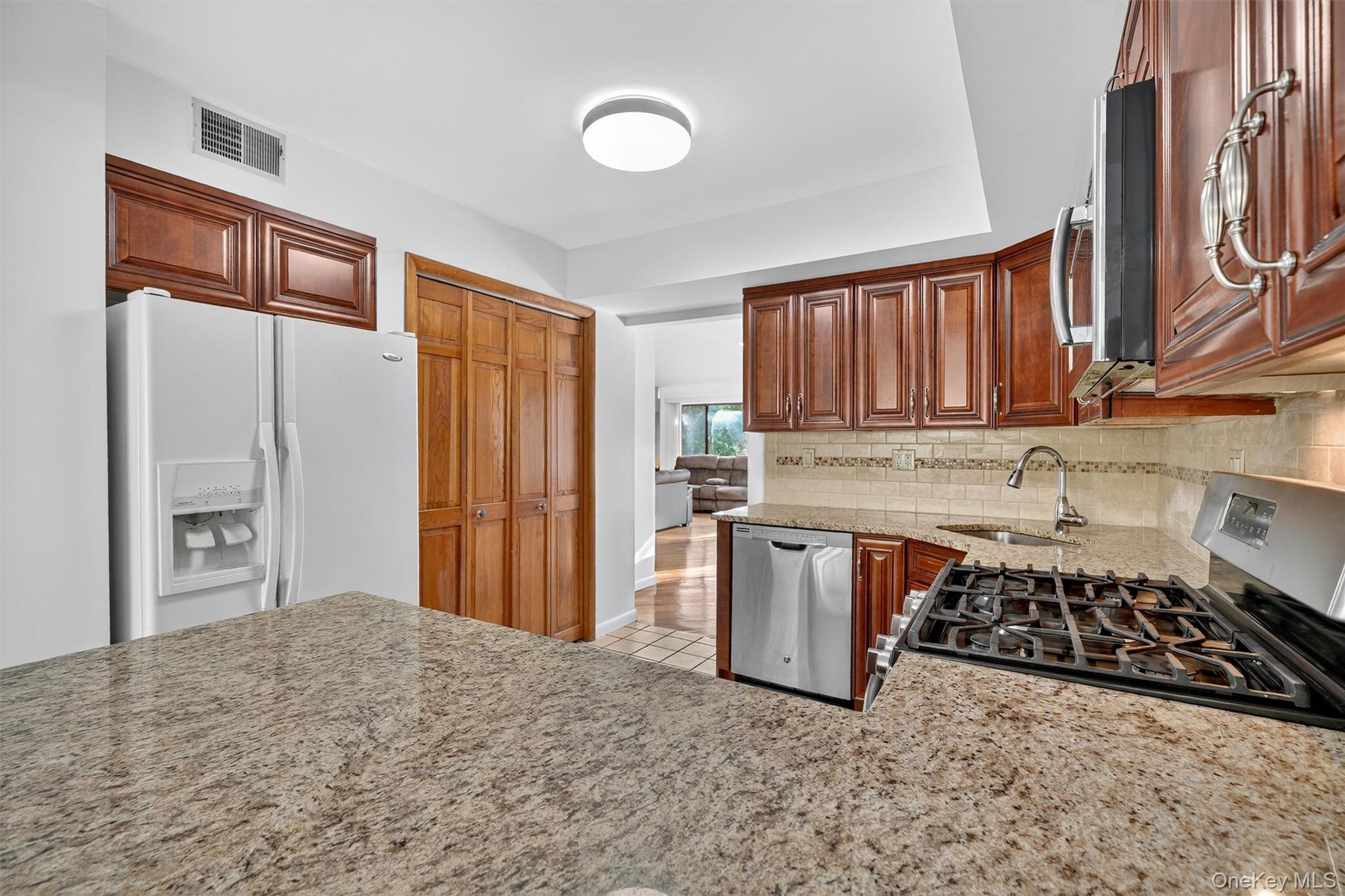 200 California Road, Unit 9 Mount Vernon, NY 10552 - Photo 6 of 50 a kitchen with stainless steel appliances granite countertop a refrigerator stove top oven and sink