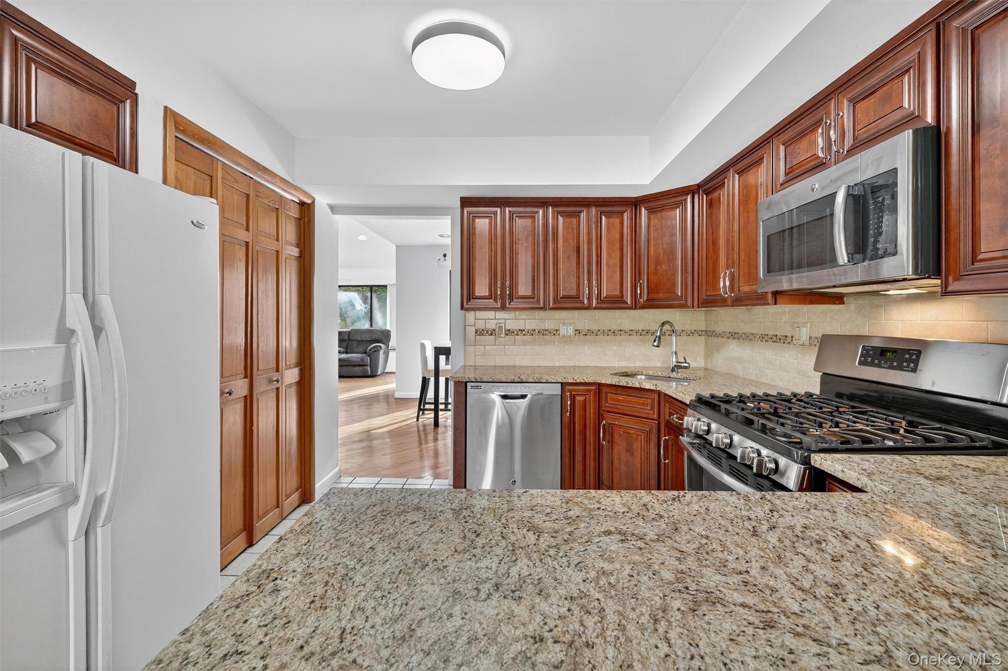 200 California Road, Unit 9 Mount Vernon, NY 10552 - Photo 7 of 50 a kitchen with stainless steel appliances granite countertop a refrigerator stove and sink