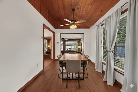 a dining room with furniture and wooden floor