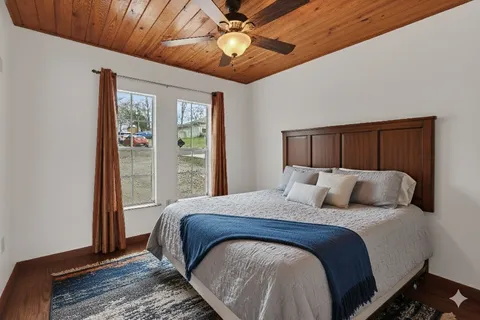 a bedroom with a large bed and a chandelier