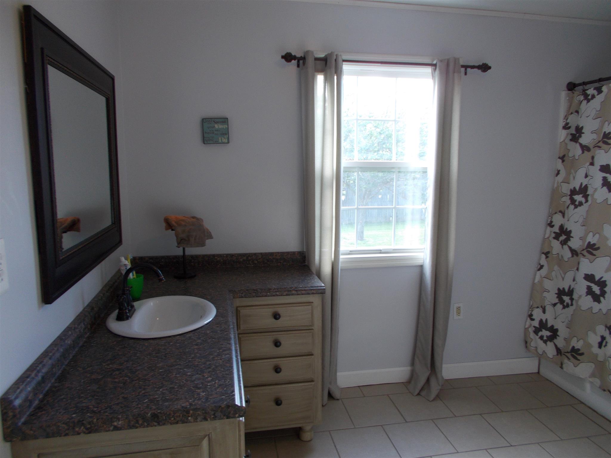 136 Westside Road Lawrenceburg, TN 38464 - Photo 12 of 30 a bathroom with a granite countertop sink and a mirror