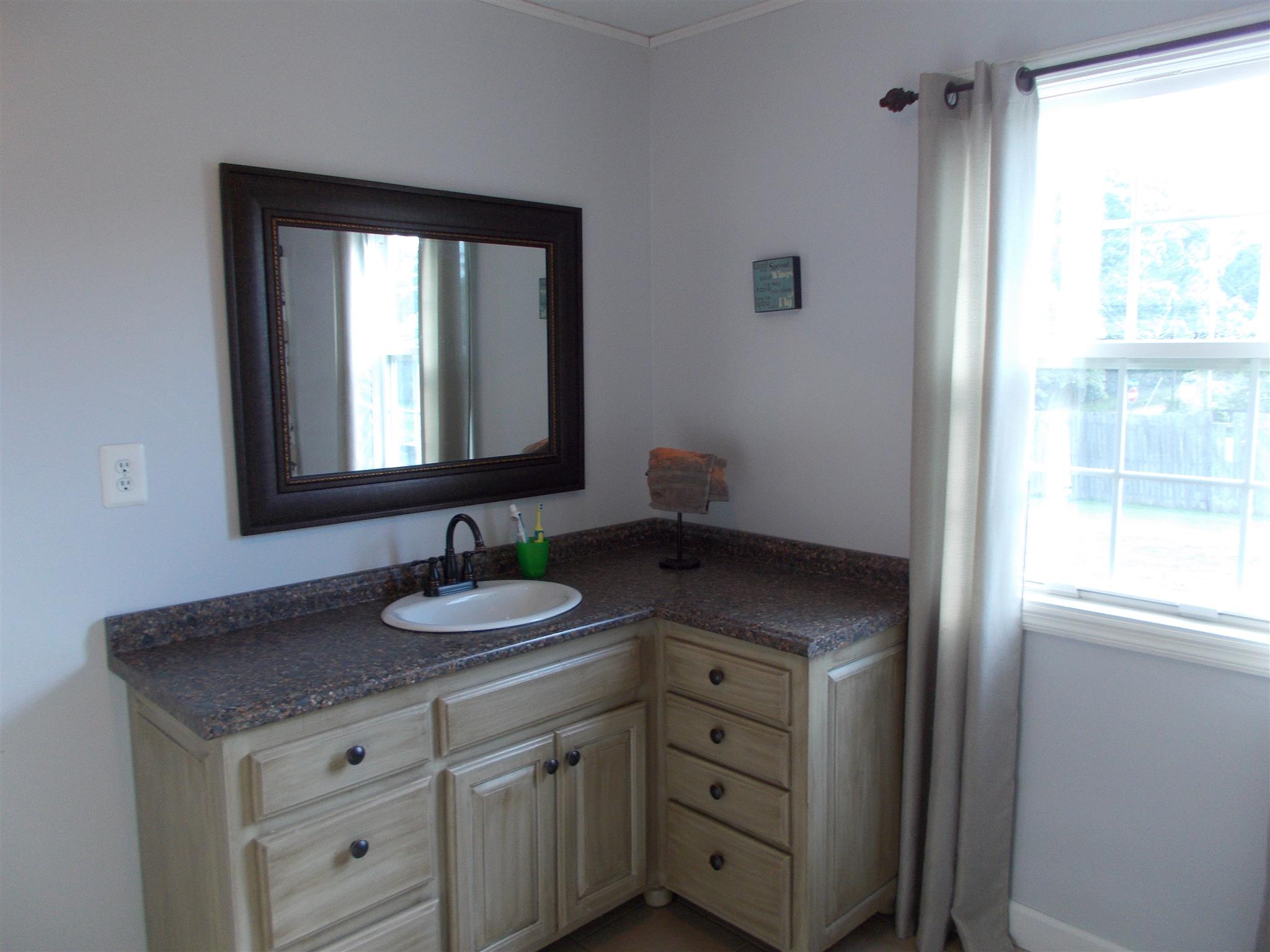 136 Westside Road Lawrenceburg, TN 38464 - Photo 13 of 30 a bathroom with a granite countertop sink and a mirror