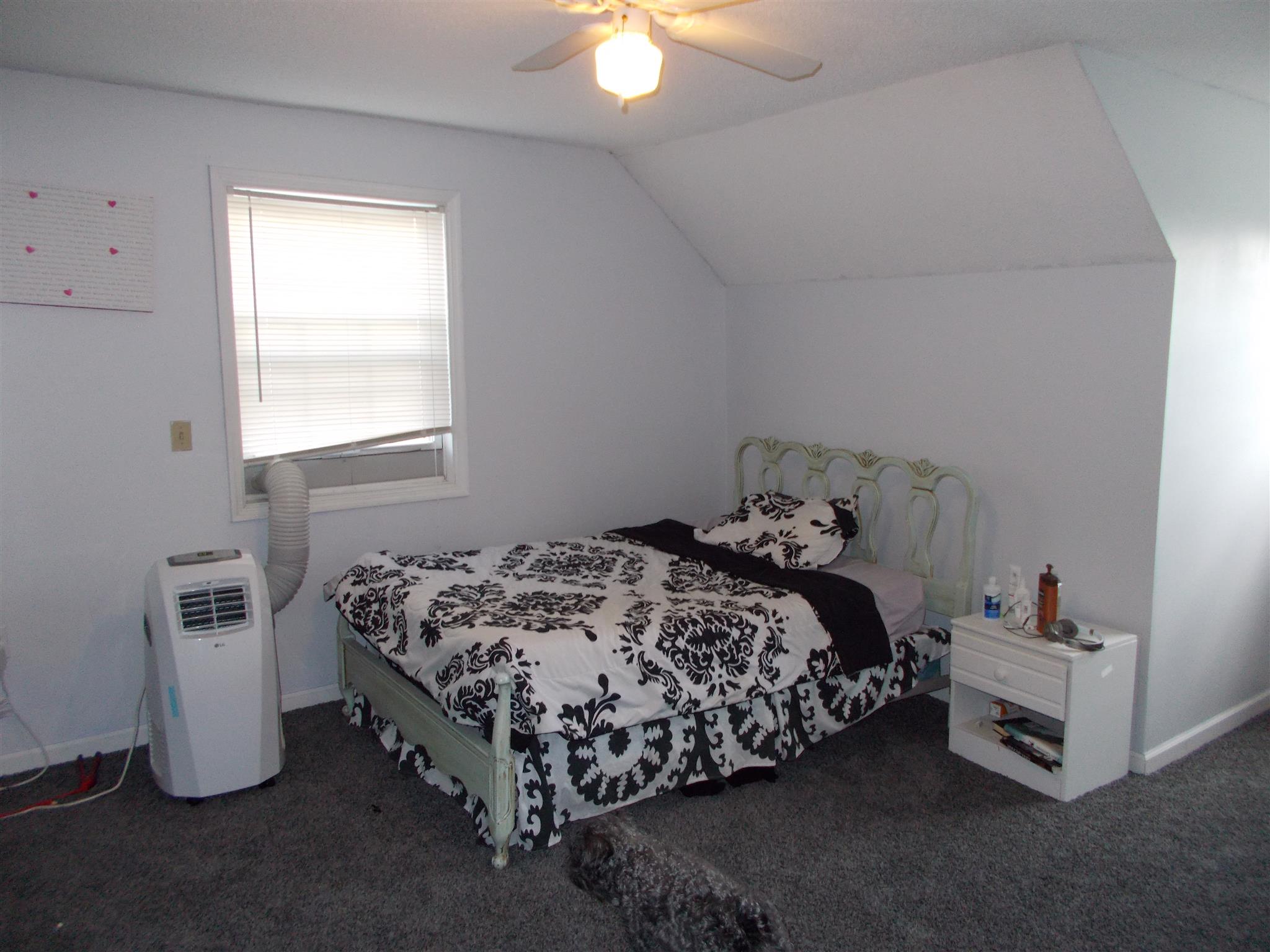 136 Westside Road Lawrenceburg, TN 38464 - Photo 15 of 30 a bed sitting in a bedroom next to a window