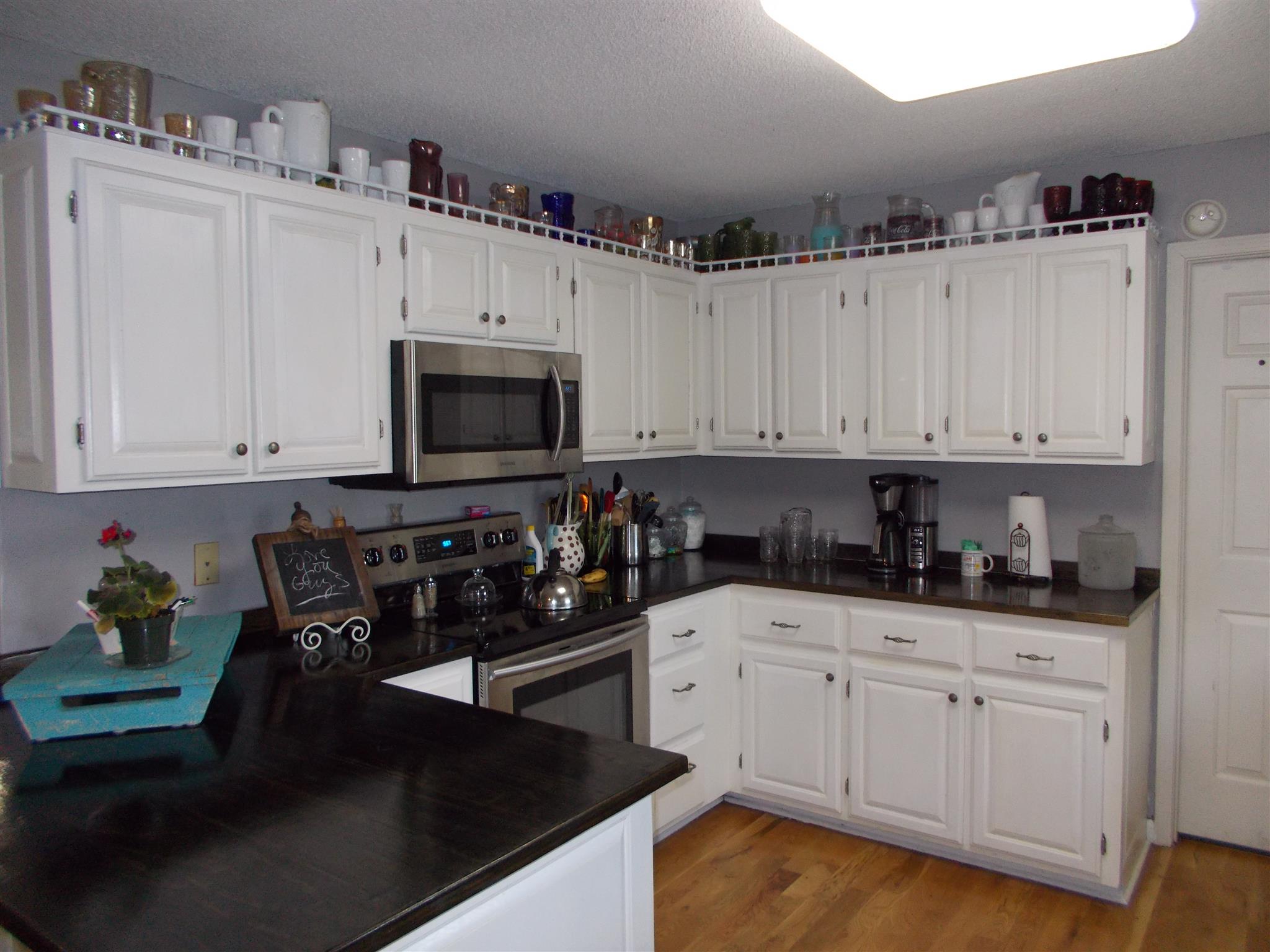 136 Westside Road Lawrenceburg, TN 38464 - Photo 4 of 30 a kitchen with white cabinets and sink