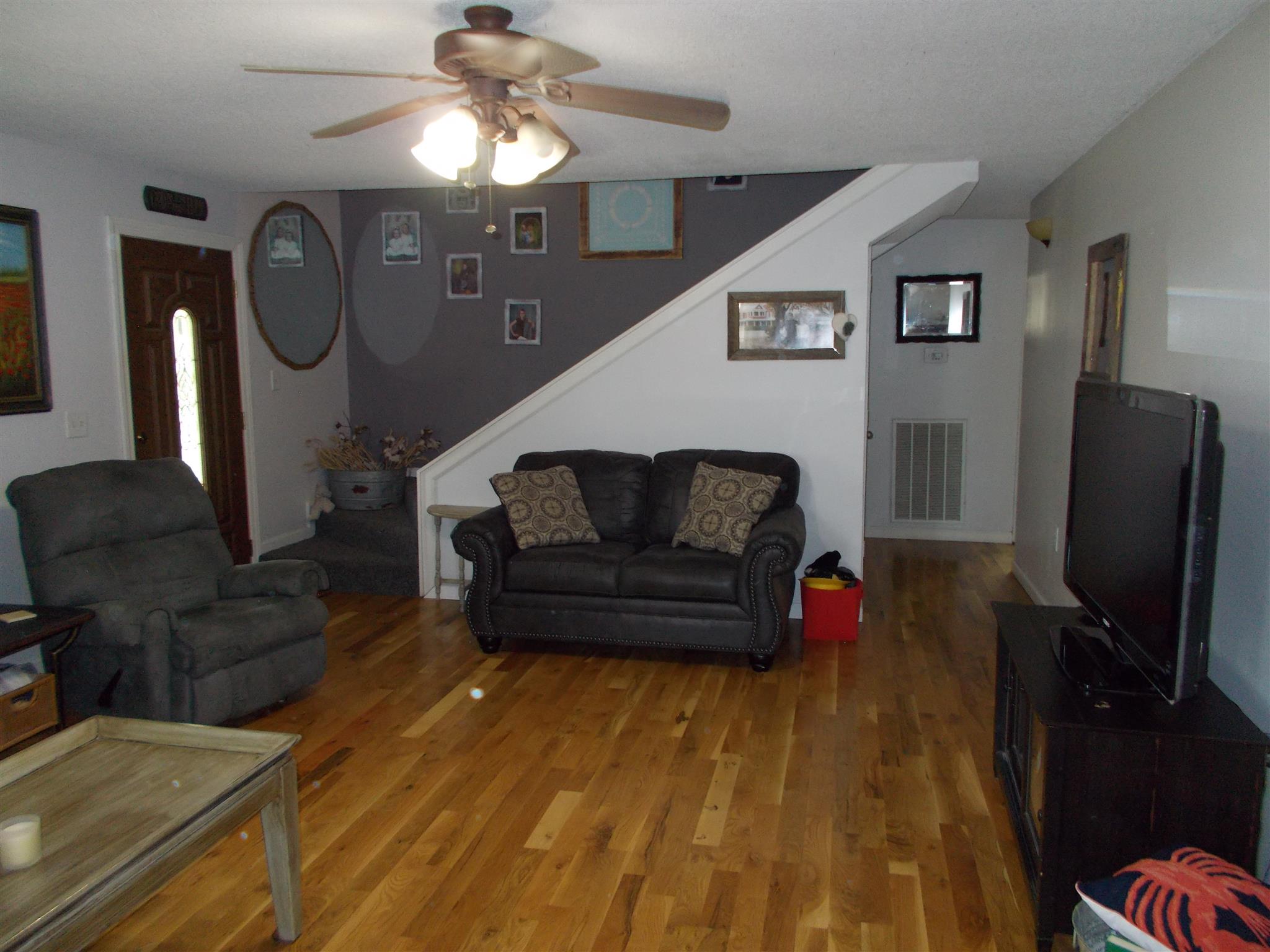 136 Westside Road Lawrenceburg, TN 38464 - Photo 8 of 30 a living room with furniture a flat screen tv and a fireplace