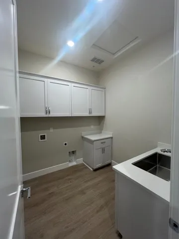 a room with a wooden floor and white walls