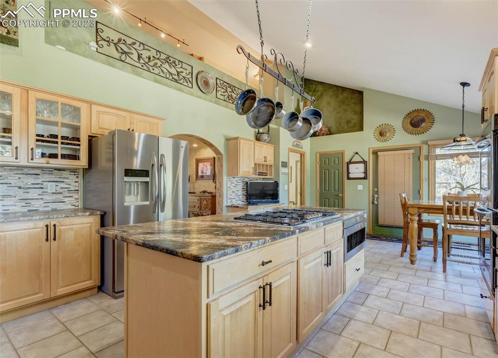 17305 Goshawk Road Colorado Springs, CO 80908 - Photo 22 of 50 a kitchen with stainless steel appliances granite countertop a sink and cabinets